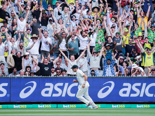 Fans cheer for Scott Boland of Australia as he takes a catch to dismiss Ollie Robison of England in the third Ashes Test at Melbourne Cricket Ground in Melbourne