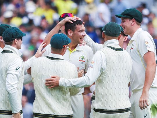 Scott Boland of Australia celebrates with teammates after taking his first Test wicket, dismissing Mark Wood of England