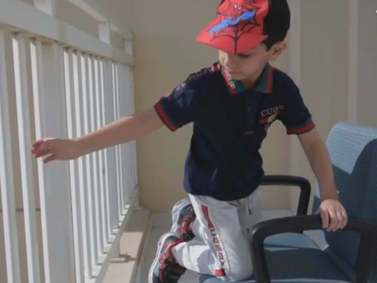 child on balcony - Abu Dhabi Police