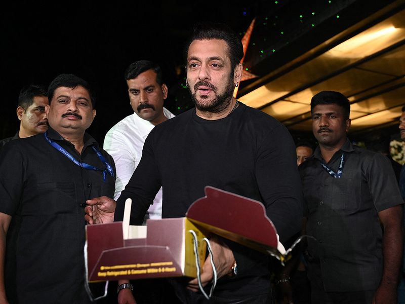 In this picture taken on December 26, 2022, Bollywood actor Salman Khan cuts a cake during his birthday celebrations in Mumbai