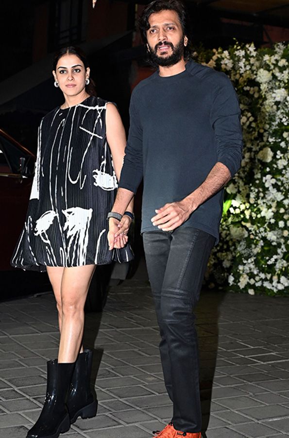 In this picture taken on December 26, 2022, Bollywood actors Genelia D’Souza and Riteish Deshmukh attend actor Salman Khan’s birthday party in Mumbai. 
