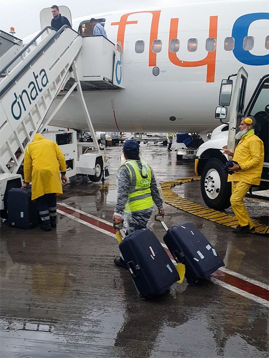 Staff working in the rain at Dubai airport on Monday morning. 