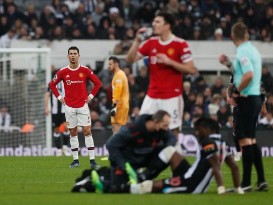 Manchester United's Cristiano Ronaldo looks on as Newcastle United's Allan Saint-Maximin receives medical attention after sustaining an injury