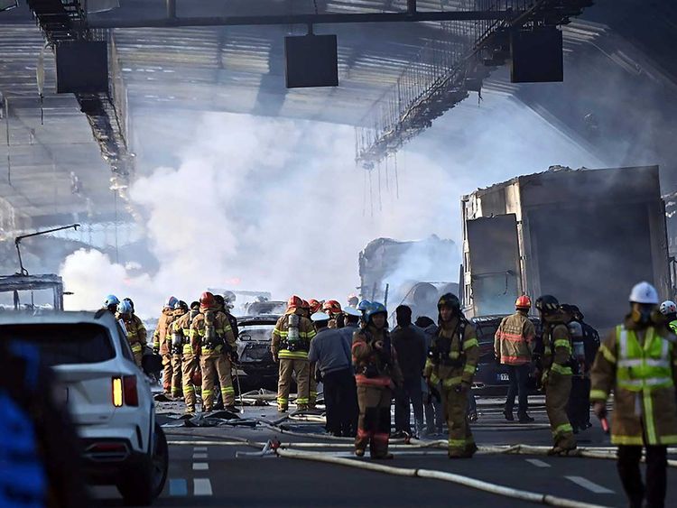 Smoke rises at the scene of a fire in Gwacheon, South Korea, Thursday, Dec. 29, 2022.  A freight truck collided with a bus on a highway near Seoul on Thursday, causing a fire that killed multiple people and injuring dozens of others 