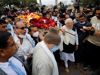 Indian Prime Minister Narendra Modi carries the body of his mother Heeraben at a crematorium in Gandhinagar, India, December 30, 2022. 