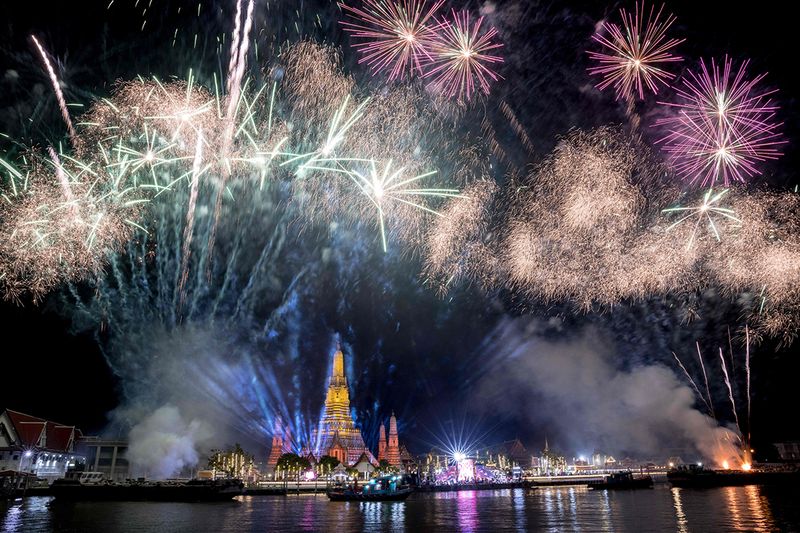 A fireworks show over Wat Arun Buddhist temple on the Chao Phraya River during New Year celebrations in Bangkok 