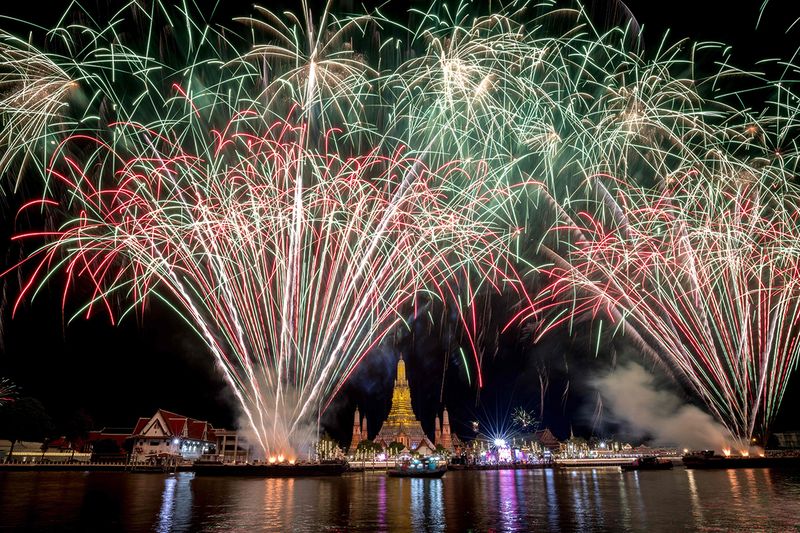 A fireworks show over Wat Arun Buddhist temple on the Chao Phraya River during New Year celebrations in Bangkok 