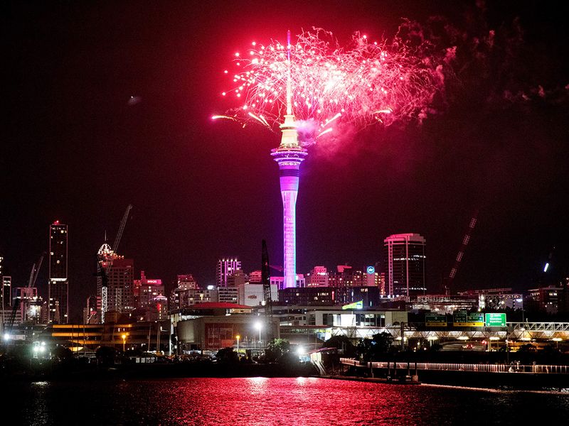 Fireworks explode over Sky Tower in central Auckland as New Year celebrations begin in New Zealand