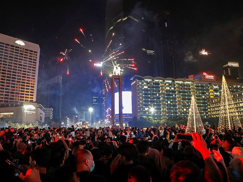 Fireworks explode over the Selamat Datang Monument during New Year's Eve celebrations in Jakarta, Indonesia