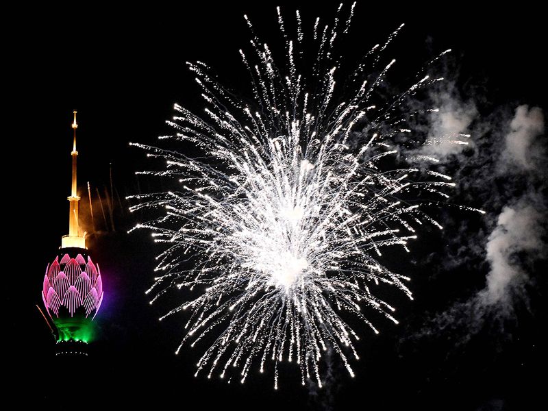 Fireworks in the sky next to the lit-up Lotus Tower during New Year celebrations in Colombo 