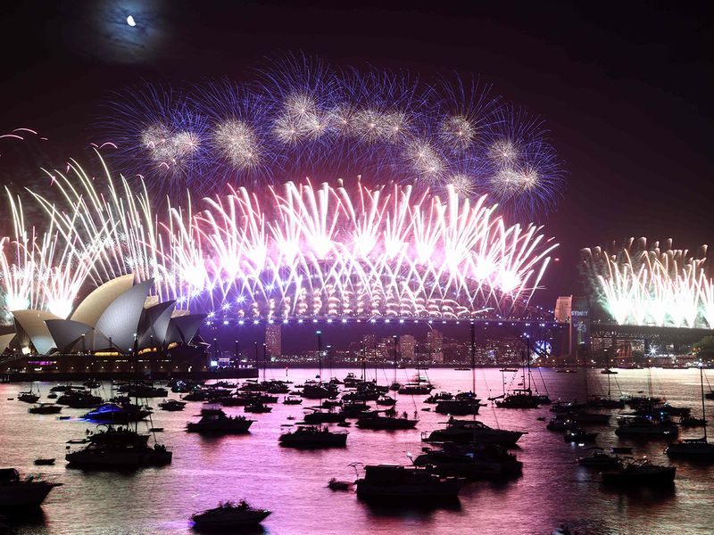 New Year's Eve fireworks light up the sky over the Sydney Opera House (L) and Harbour Bridge during the fireworks display in Sydney