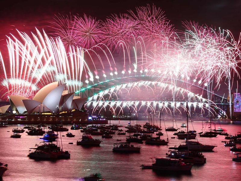 New Year's Eve fireworks light up the sky over the Sydney Opera House (L) and Harbour Bridge during the fireworks display in Sydney