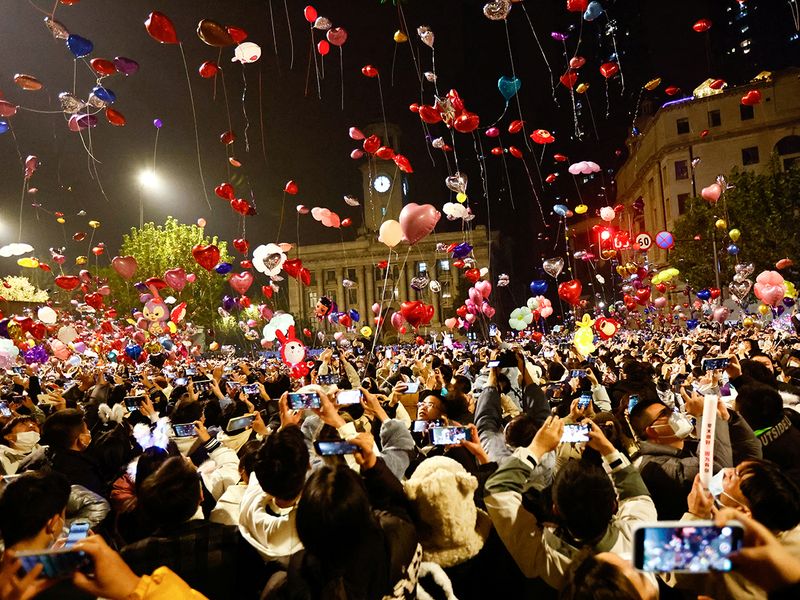 People release balloons as they gather to celebrate New Year's Eve, in Wuhan, Hubei province, China 