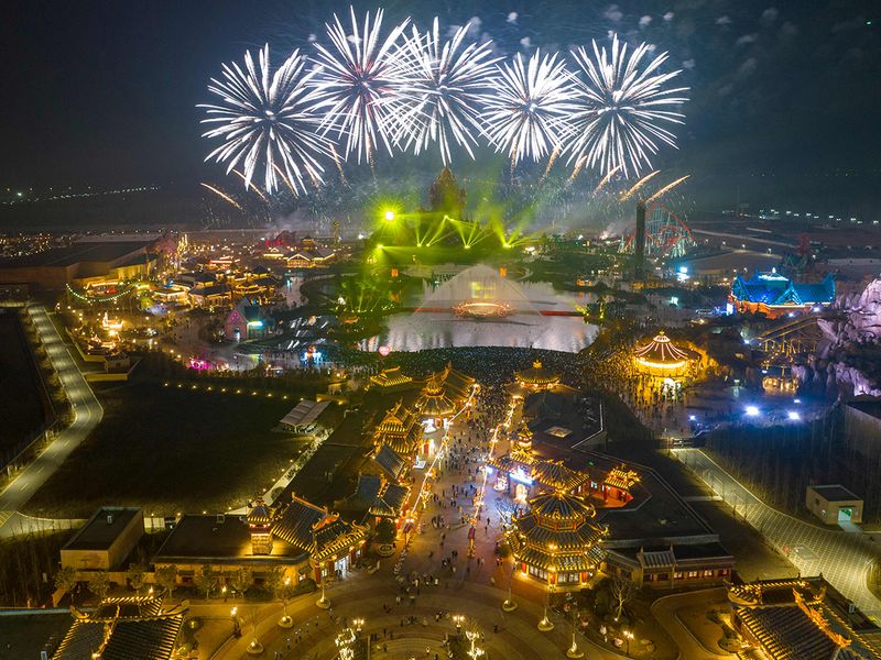 This aerial photo shows fireworks lighting up the sky over the Xiyou World theme park during New Year celebrations in Huaian, in China's eastern Jiangsu province 