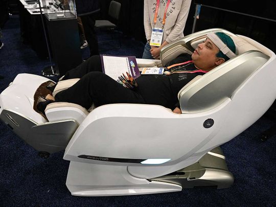 An attendee tries the Bodyfriend Phantom Medical Care massage chair during CES Unveiled ahead of the Consumer Electronics Show (CES) on January 3, 2023 in Las Vegas, Nevada. 