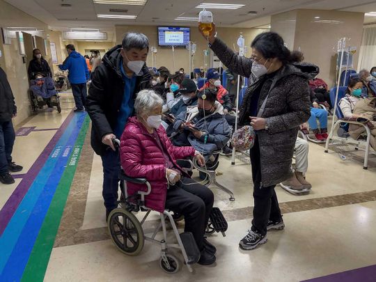 An elderly patient is pushed along a corridor of the emergency ward providing intravenous drips Tuesday, Jan. 3, 2023. As the virus continues to rip through China, global organizations and governments have called on the country start sharing data while others have criticized its current numbers as meaningless 