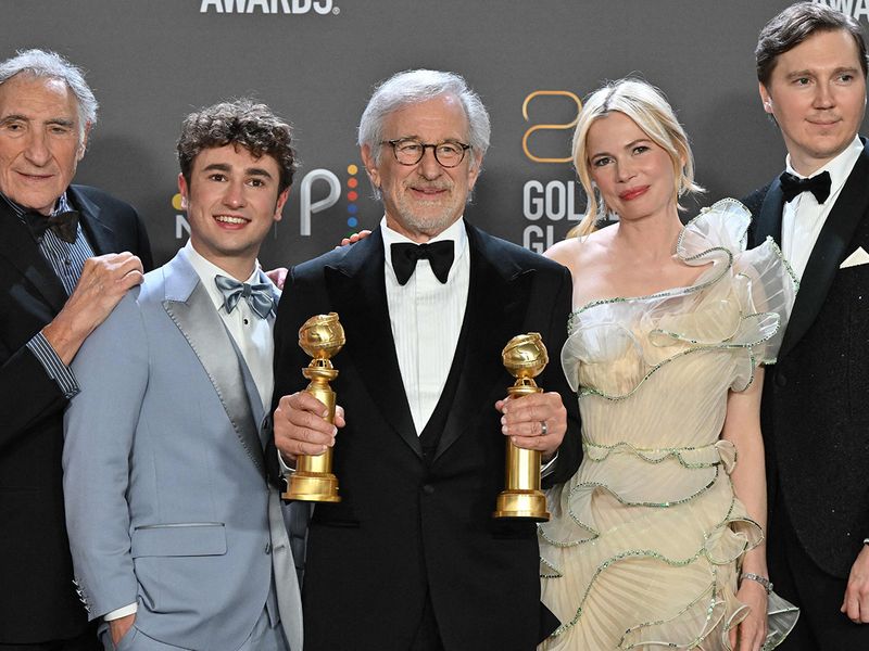 US director Steven Spielberg (C) poses with the awards for Best Director - Motion Picture and Best Picture - Drama for 
