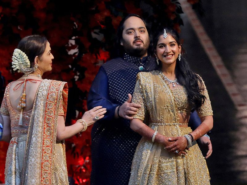 Anant Ambani, son of Mukesh Ambani, the Chairman of Reliance Industries, and Radhika Merchant, daughter of Encore Healthcare CEO Viren Merchant, pose during a photo opportunity at the Red Carpet ceremony to celebrate their engagement at Ambani's Antilia residence in Mumbai, India, January 19, 2023