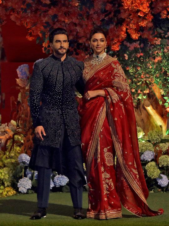 Actor Ranveer Singh and his wife actor Deepika Padukone pose during a photo opportunity as they arrive to attend the engagement ceremony of Anant Ambani, son of Mukesh Ambani, the Chairman of Reliance Industries, and Radhika Merchant, daughter of Encore Healthcare CEO Viren Merchant, at Ambani's Antilia residence in Mumbai, India, January 19, 2023. 