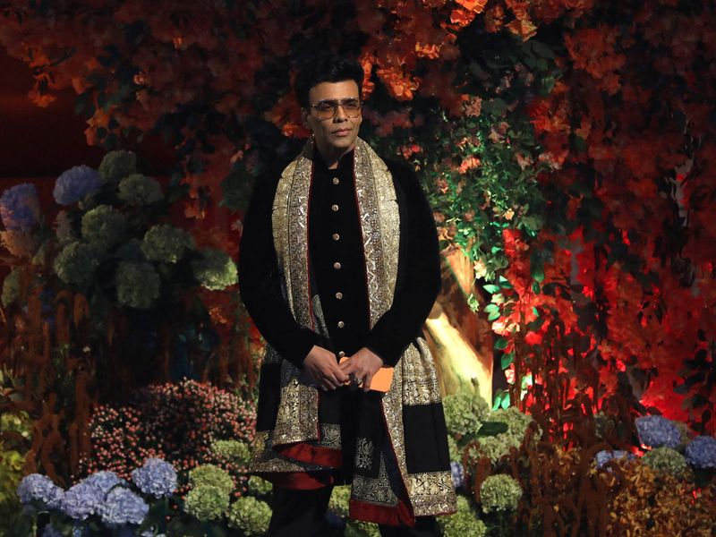 Director Karan Johar poses during a photo opportunity as he arrives to attend the engagement ceremony of Anant Ambani, son of Mukesh Ambani, the Chairman of Reliance Industries, and Radhika Merchant, daughter of Encore Healthcare CEO Viren Merchant, at Ambani's Antilia residence in Mumbai, India, January 19, 2023