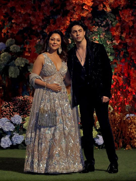 Gauri, wife of actor Shah Rukh Khan, and her son Aryan Khan pose during a photo opportunity as they arrive to attend the engagement ceremony of Anant Ambani, son of Mukesh Ambani, the Chairman of Reliance Industries, and Radhika Merchant, daughter of Encore Healthcare CEO Viren Merchant, at Ambani's Antilia residence in Mumbai, India, January 19, 2023. 