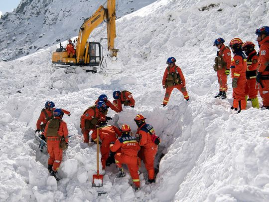 Rescuers search for survivors following an avalanche in Nyingchi, southwest China's Tibet Autonomous Region. 
