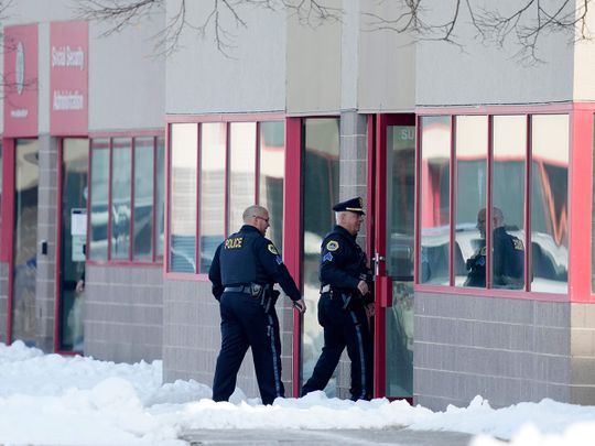 Law enforcement officers enter the Starts Right Here building after the shooting incident, in Des Moines, Iowa.  