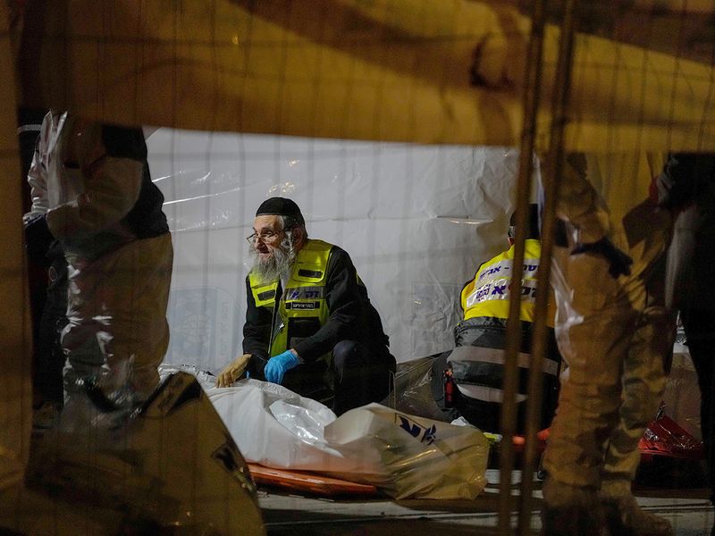 Members of Zaka Rescue and Recovery team check victims of a shooting attack near a synagogue in Jerusalem, on Friday, January 27, 2023. 