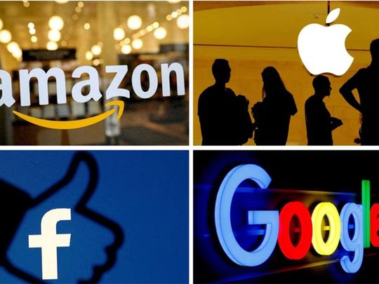 The logos of Amazon, Apple, Facebook and Google in a combination photo.
