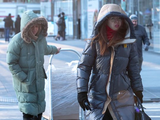 People bundled up against winter weather walk in midtown Manhattan 