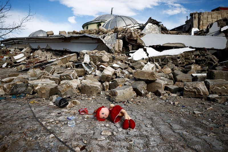 A doll lies on the ground near the site of a collapsed mosque, following an earthquake in Hatay.
