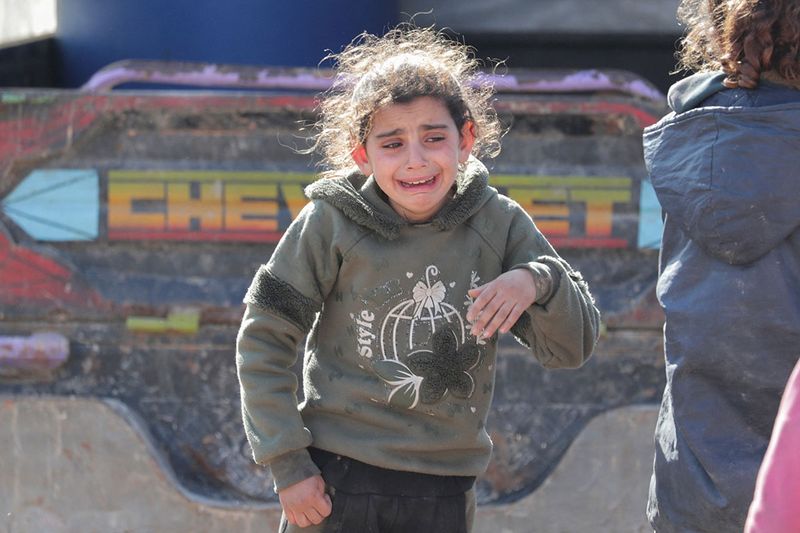 A girl reacts following an earthquake, in rebel-held town of Jandaris, Syria.