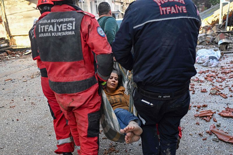 A woman is rescued after surviving the earthquake in Hatay, Turkey. 