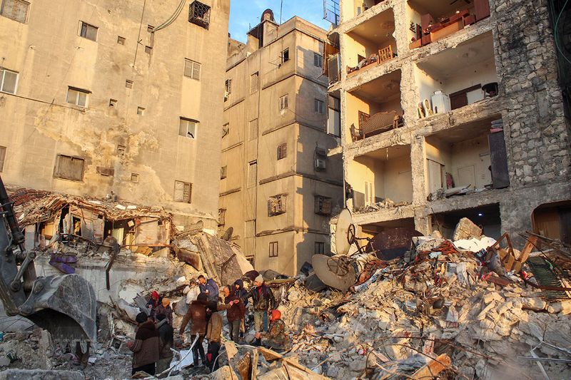 People gather on the rubble as the search for survivors continues, in the aftermath of the earthquake, in Aleppo, Syria February 7, 2023.i
