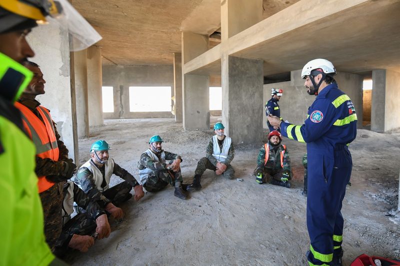 UAE rescue and search team member (right) briefing the team from Syrian Civil Defence