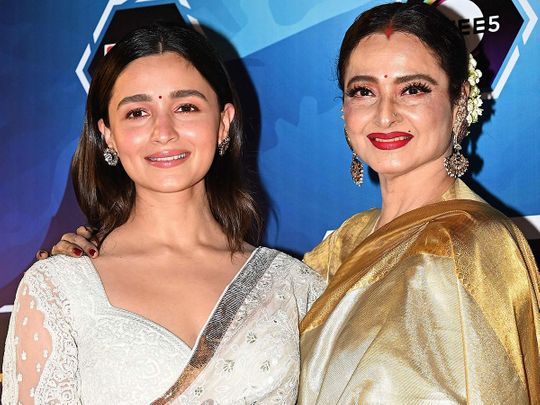 Bollywood actress Alia Bhatt (L) and Rekha (R) attend the ‘Dadasaheb Phalke International Film Festival awards night of 2023’ in Mumbai on February 20, 2023. 