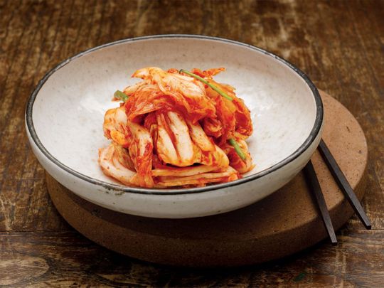 Korea’s famous pickled side dish, kimchi, is made with fermented vegetables – usually napa cabbage – in a spicy red paste.