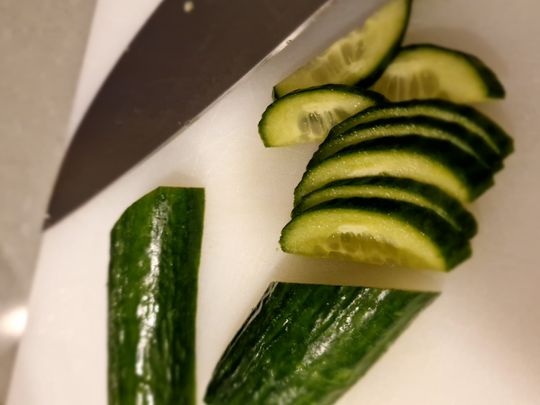 1. Cut the cucumbers lengthwise in half and cut diagonally into thin slices.