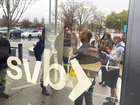 People line up outside of the shuttered Silicon Valley Bank (SVB) headquarters on March 10, 2023 in Santa Clara, California.