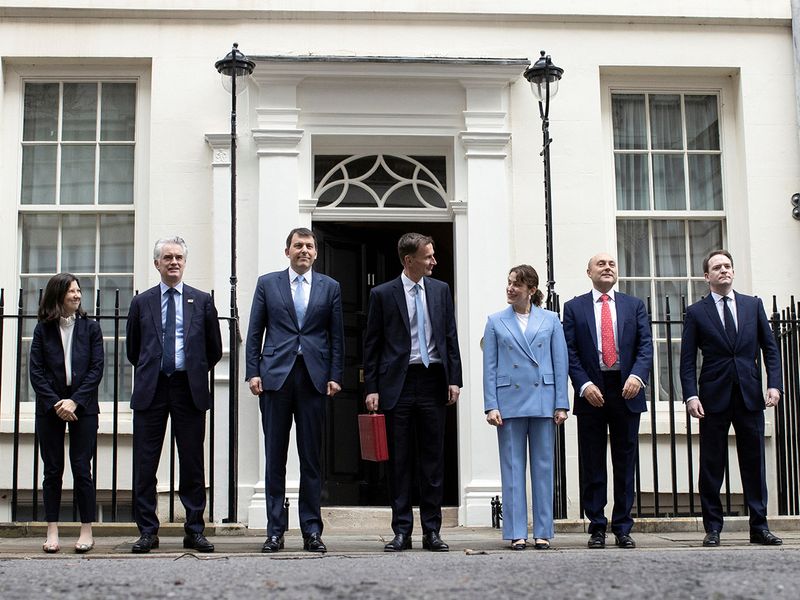 Britain's Chancellor of the Exchequer Jeremy Hunt holds the budget box as he poses with his treasury team at Downing Street in London, Britain March 15, 2023.