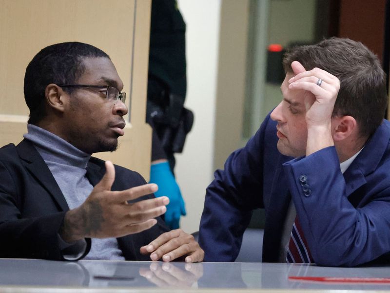 Shooting suspect Michael Boatwright talks to his attorney during the trial.