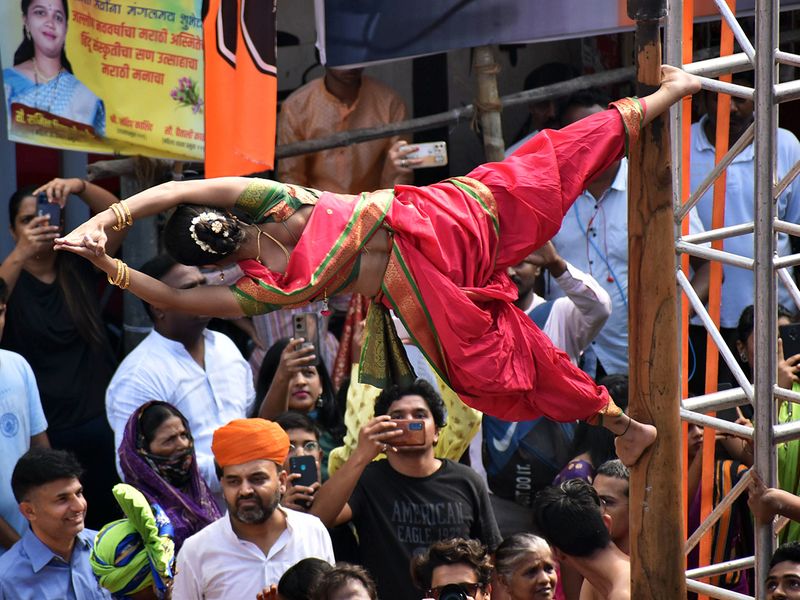An artist performs in a procession in Mumbai.