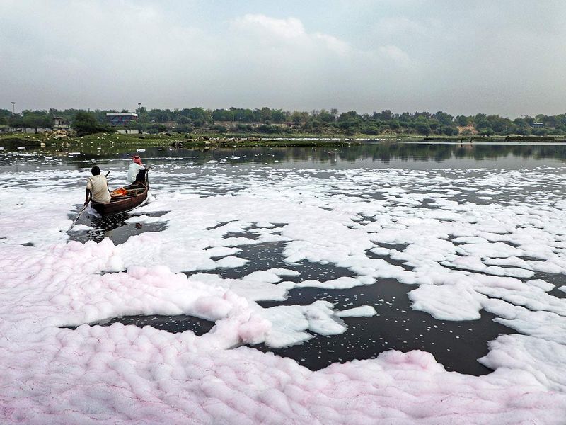Lucknow, Mar 21 (ANI): A man rows a boat through the polluted water of Gomti river, on the eve of World Water Day, in Lucknow on Tuesday.