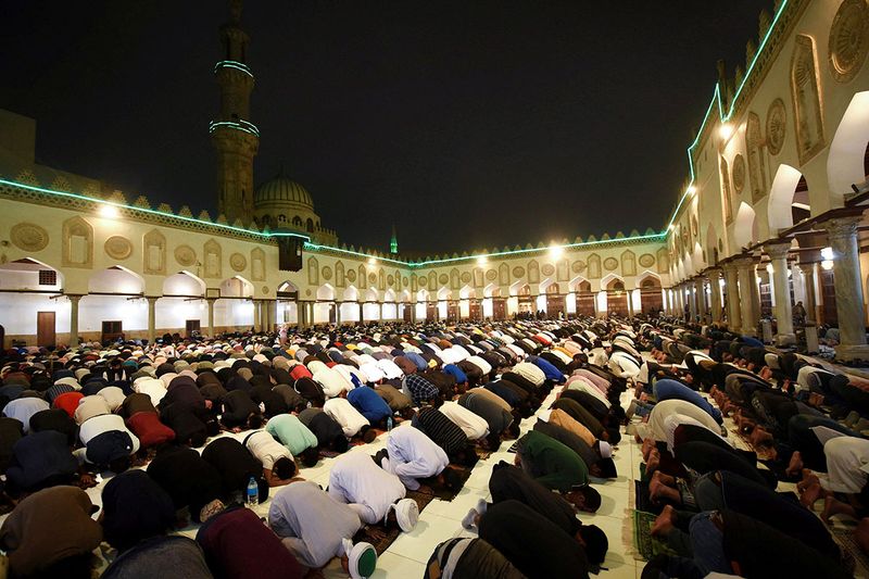 Muslim worshippers perform evening prayers called 