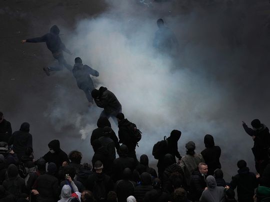 Protesters scuffle at the end of a rally in Paris