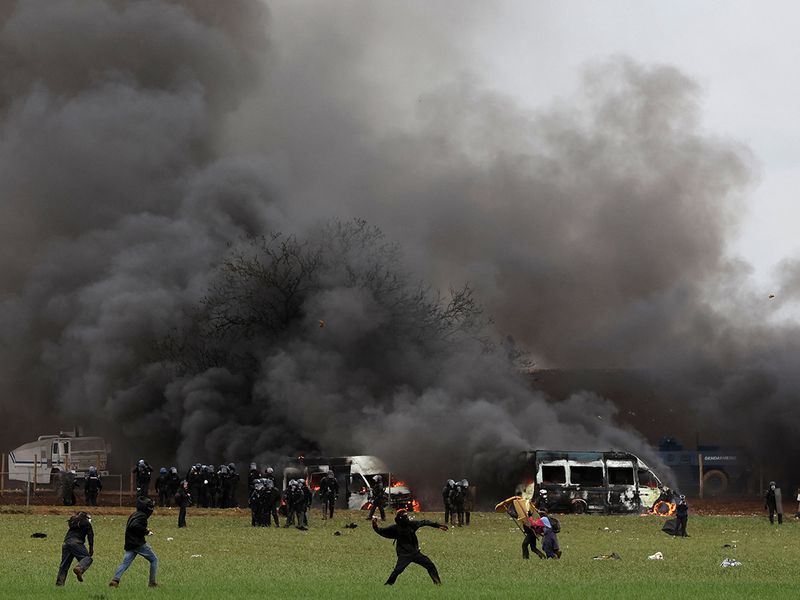 Protesters clash with riot mobile gendarmes during a demonstration called by the collective 