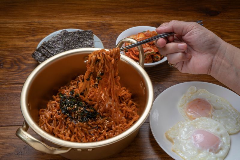 Korean ramyeon typically features a spicy broth or sauce made from a mix of gochujang (red pepper paste), gochugaru (red pepper flakes), and other spices