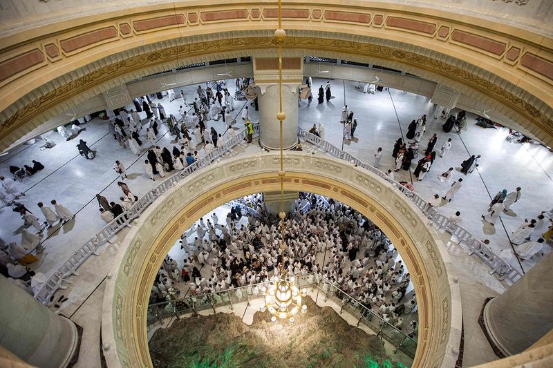Muslim worshippers walk at the Grand Mosque in the holy city of Mecca during the second Friday prayers in the holy month of Ramadan. 