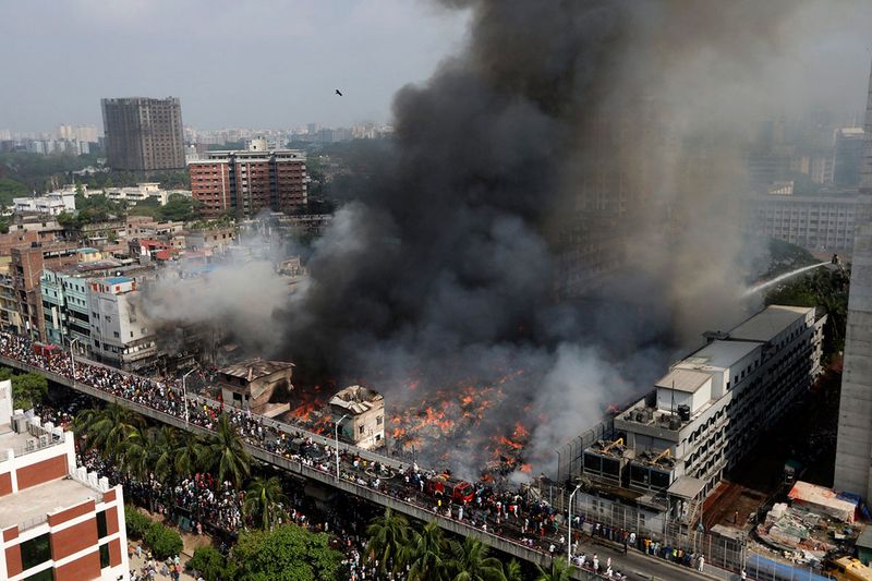 A fire rages at a popular market for cheaper clothes in Bangladesh's capital Dhaka, Bangladesh, Tuesday, April, 4, 2023. The fire broke out at Bangabazar Market in Dhaka on Tuesday, but no casualties were reported immediately. 