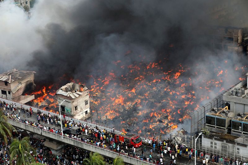 A fire rages at a popular market for cheaper clothes in Bangladesh's capital Dhaka, Bangladesh, Tuesday, April, 4, 2023. The fire broke out at Bangabazar Market in Dhaka on Tuesday, but no casualties were reported immediately.